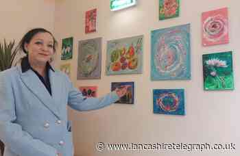 Artist donates paintings to Blackburn community centre