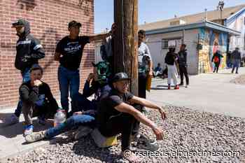 View photos of migrants sheltering on city streets near Sacred Heart Church