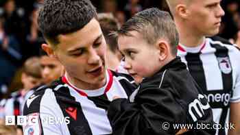 Grimsby Town fan, 6, leads team out after open heart surgery