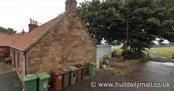 Cottage owner at loggerheads with council and neighbours over 'alien' garden room