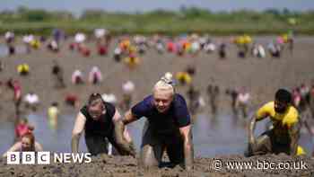 Hundreds battle across muddy riverbed for charity