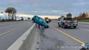 Vehicle mounts guardrail on Highway 400 in Barrie