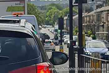 Traffic is being diverted after a car overturned in Darwen