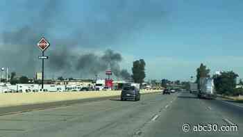 Crews battling fire at junkyard in Fresno