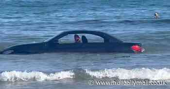 Flashy BMW convertible washed out to sea after parking on beach