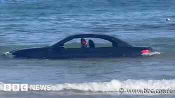 Car in sea at Trevaunance Cove, St Agnes