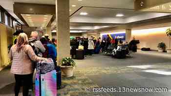 Dozens of travelers wait in airport terminals as bad weather delays flights