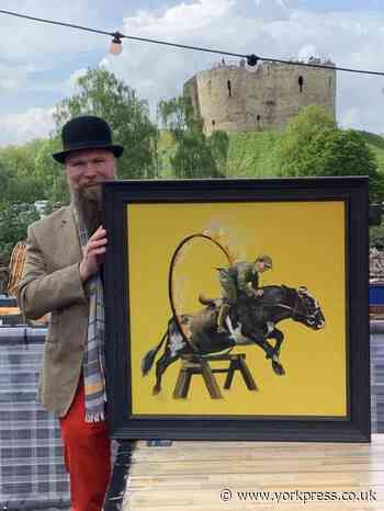 York artist depicts farmer riding bull through ring of fire