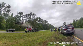 Police video shows a car rocketing off a tow truck on a Georgia highway