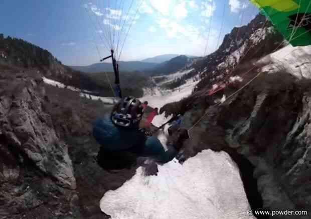 Skier Equipped With Paraglide Wing Buzzes Alpine Waterfall
