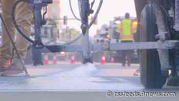 Blue stripe painted on Denver street for Nuggets parade