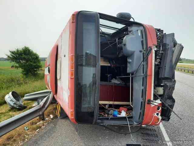 Driver rolls tour bus after hitting semi on I-65