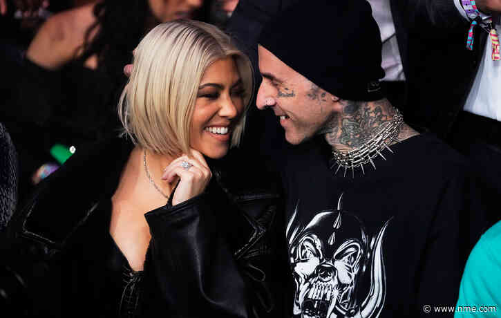Kourtney Kardashian holds up sign at Blink-182 gig to tell Travis Barker she’s pregnant