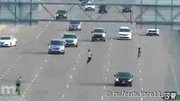WATCH: Man and woman run across traffic on I-35E to flee police