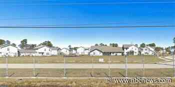 A Navy base put up a wall of shipping containers to protect against stray bullets