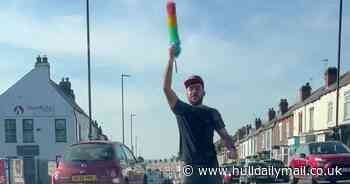 Watch: 'Hero' barber 'flamboyantly' conduct traffic with rainbow feather duster after lights fail