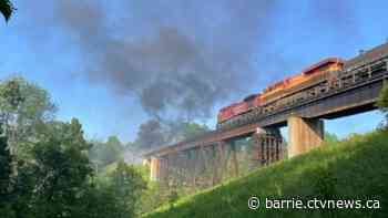 Train track trestle bridge catches fire in Utopia