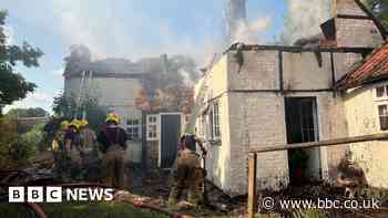 Wiltshire builders save woman and dogs from burning home