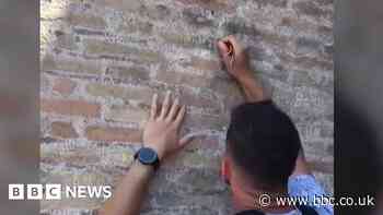 Police hunt man filmed carving names on Colosseum