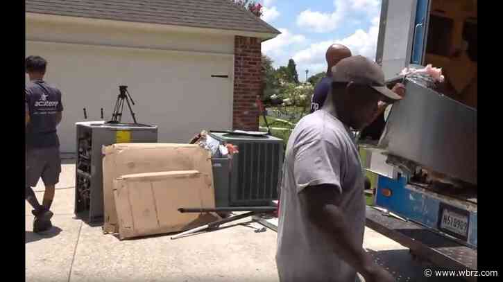 A/C technicians work in the heat to keep you cool