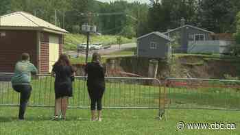 N.B. couple barred from home sitting on edge of massive hole after torrential rain