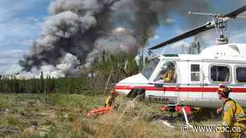 Rains aid battle against wildfire threatening northern Alberta hamlet