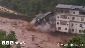 Building collapses into raging China floodwaters