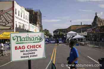 Eating legend Joey Chestnut shakes off rain to defend hot dog title