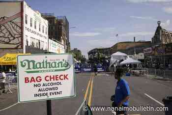 Eating legend Joey Chestnut shakes off rain to defend hot dog title
