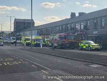 Ambulances, police cars and fire engines are at Colne Road