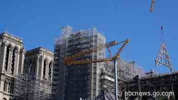 Crane at fire-ravaged Notre Dame hoists giant wood trusses to the cathedral's roof