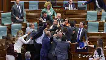 Kosovo's PM gets doused with water, inciting a brawl in parliament
