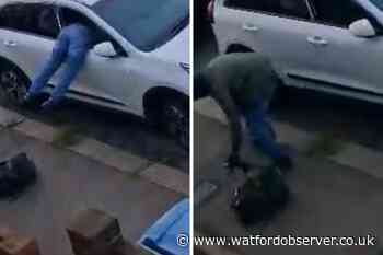 Thief caught on camera hanging out of Watford car window