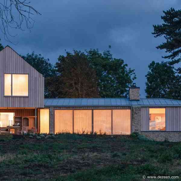 Weathered stone and larch clad Cotswolds House by Oliver Leech Architects