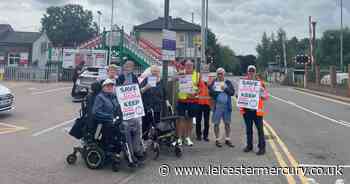 Worried passengers protest outside railway station over potential ticket office closure