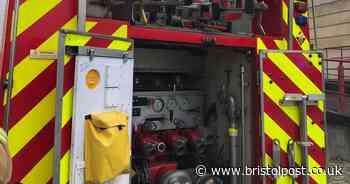 Flooded flats cause chaos for residents and Bristol road is blocked by firefighters at the scene