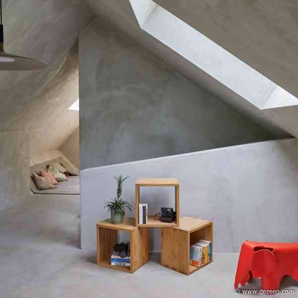 Sculptural blocks intersect to form barn-like house in Switzerland