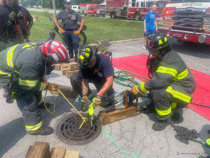 Indianapolis police see hand sticking out of manhole cover, woman saved from sewer