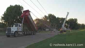 Crews work to restore power after dump truck hits power line in Anoka