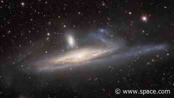 Dark energy camera reveals galaxies caught in a cosmic 'tug of war' (photo)