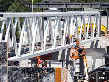 Western section of Queensway to re-open Monday morning following pedestrian bridge installation