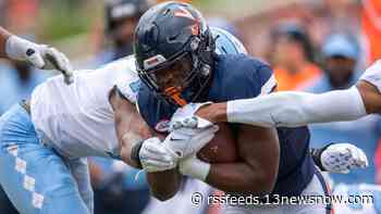 UVA running back Mike Hollins carries his former teammates' flames this season