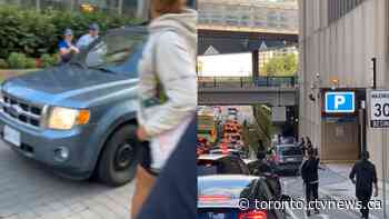 Video surfaces of car driving onto sidewalk, nearly hitting dozens of pedestrian in downtown Toronto