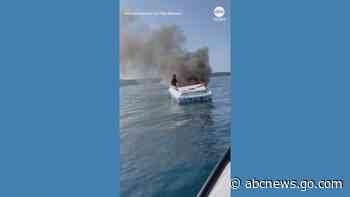 WATCH:  Couple rescues pair from burning boat on Lake Michigan