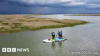Friends paddle around Mersea Island on giant SUP for RNLI