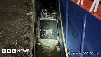 Man and his dog rescued from trapped boat