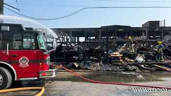 Parts of Logan Avenue building demolished as firefighters continue to battle blaze