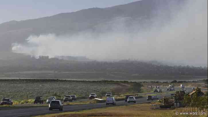 Hawaii wildfires burn homes and force evacuations, while strong winds complicate the fight
