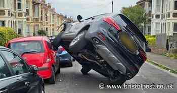 Driver crashes wheel through parked car's window in baffling images