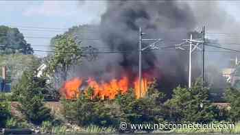 Shed fire in Mystic briefly halts Amtrak service